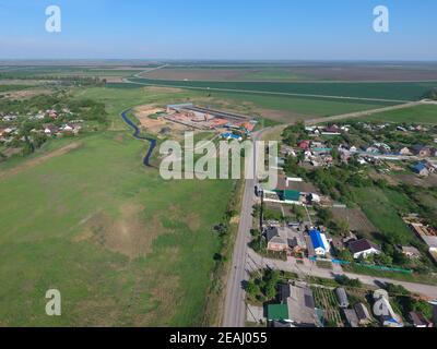 Top view of the village. One can see the roofs of the houses and gardens. Road and water in the village. Village bird's-eye view Stock Photo