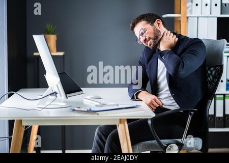 Young Man With Tense Neck Pain Stock Photo