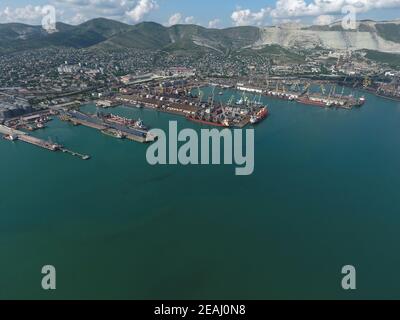 Industrial seaport, top view. Port cranes and cargo ships and barges. Stock Photo