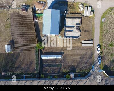 Buildings on the site. Hangar from metal profile, corrugated. The foundation of the house. Stock Photo