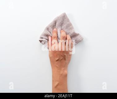 A man's hand on a white background with a rag Stock Photo