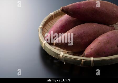 Sweet potatoes on a black background Stock Photo