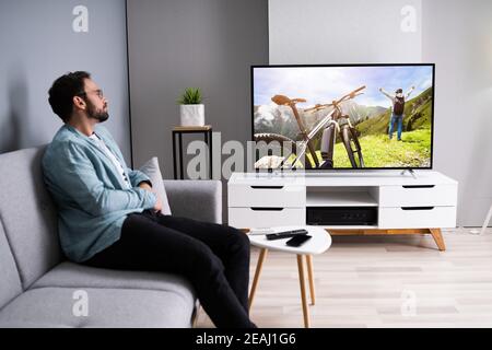 Watching TV Movie On Couch Stock Photo