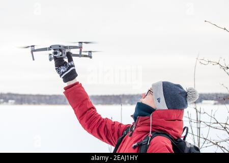 Russia Vyborg. 02.02.2021 A young man launches a quadcopter in winter. High quality photo Stock Photo
