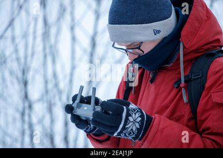 Russia Vyborg. 02.02.2021 A young man launches a quadcopter in winter. High quality photo Stock Photo