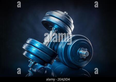 dumb bells against a black background Stock Photo