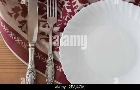 A white empty plate on a linen napkin Stock Photo