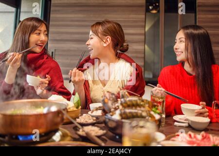 happy young friends  having fun in hot pot restaurant Stock Photo