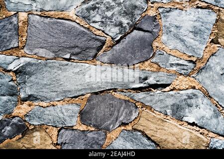 Pattern Gray Color of Modern Style Design Decorative Uneven Cracked Real Stone Wall Surface With Cement Stock Photo