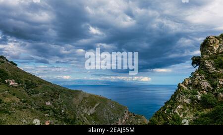between sky and sea black clouds. Stock Photo