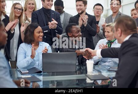 business people shaking hands over an office Desk. Stock Photo