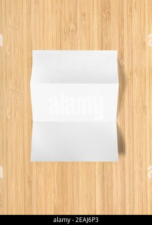 Blank folded White A4 paper sheet mockup template on wooden background Stock Photo