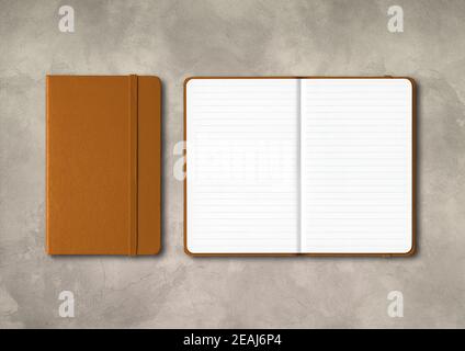 Leather closed and open lined notebooks on concrete background Stock Photo