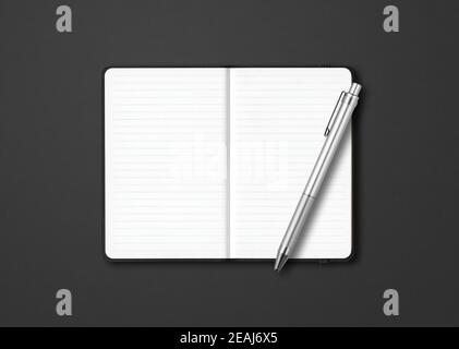 Black open lined notebook with a pen isolated on dark background Stock Photo