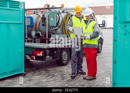 Workers doing some logistics in the rental toilet business Stock Photo