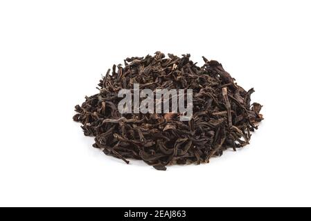 Dried tea poured a slide on a white background. Is isolated. Stock Photo