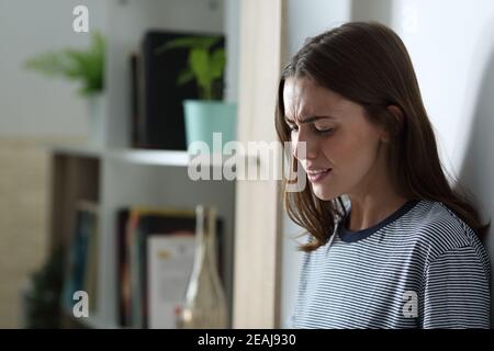 Sad girl crying alone at home in the night Stock Photo