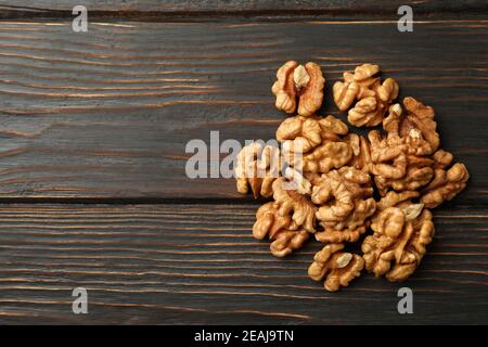 Heap of tasty walnuts on wooden background Stock Photo