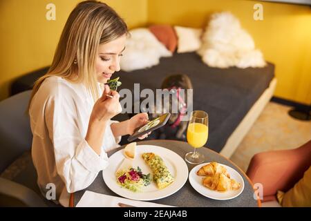 Woman taking a picture of her food at breakfast Stock Photo