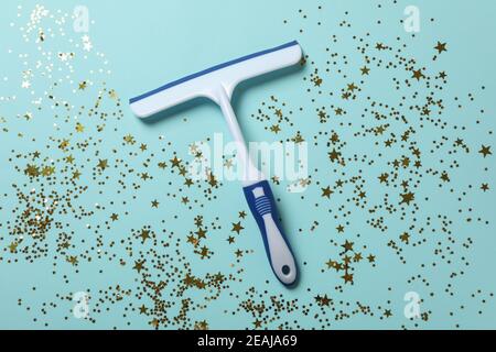 Window cleaning squeegee on blue background with glitter Stock Photo