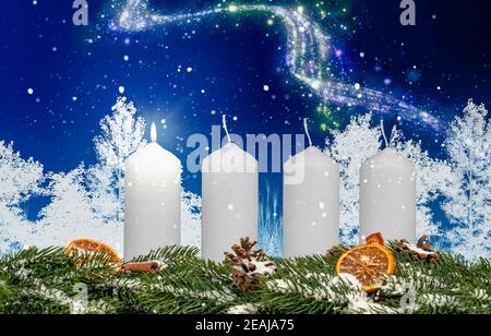 one candle on an advent wreath burns with wintery background Stock Photo