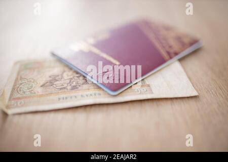 Fifty Burmese Kyats Bill Partially Inside a Sweden Passport Stock Photo