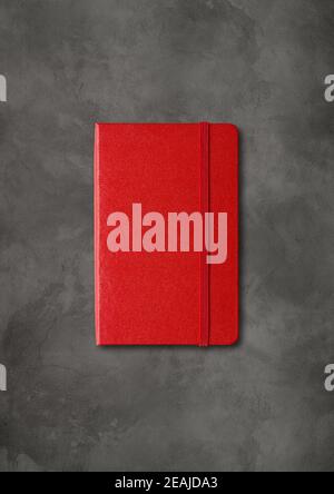 Red closed notebook on dark concrete background Stock Photo