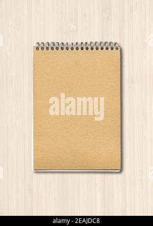 Spiral closed notebook mockup on white wood background Stock Photo