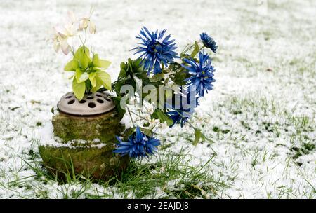 Artificial flowers on a grave in winter, Warwick, UK Stock Photo
