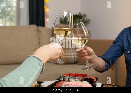 Two women friends sitting by table and eating sushi. Family, friendship and communication concept. Stock Photo