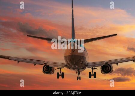 big plane landing during sunset Stock Photo