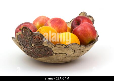 fresh fruits in a clay bowl Stock Photo