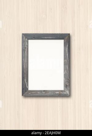 Old rustic wooden picture frame hanging on a wood wall Stock Photo