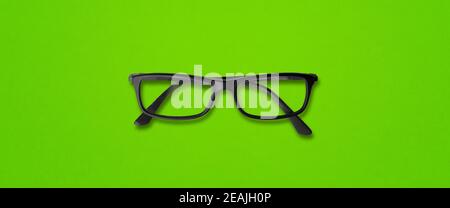 Black glasses isolated on green banner Stock Photo