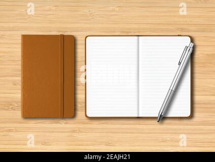 Leather closed and open lined notebooks with a pen on wooden background Stock Photo