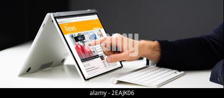 Read Online News Media On Laptop Stock Photo
