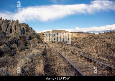 The old, abandoned Milwaukee Road railroad tracks, up on Spire Rock Flats, on a cold winter afternoon, near Pipestone, in Jefferson County, Montana. T Stock Photo