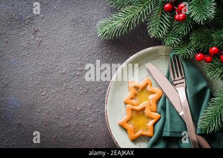 Christmas festive table setting with xmas decorations on dark Stone background. Copy space. Stock Photo