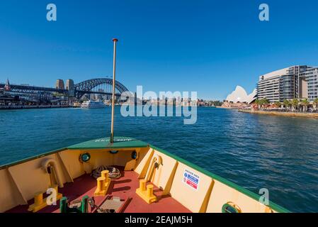 Looking over the bow of a Manly Ferry as it leaves the terminal (wharf) at Circular Quay, Sydney, New South Wales, Australia Stock Photo