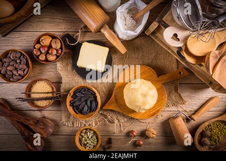 Assortment of baking ingredients and kitchen utensils in vintage wooden style Stock Photo