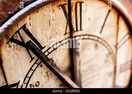 Old vintage and retro analogue clock displaying five minutes to twelve. Stock Photo