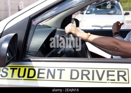 Student driver holding steering wheel during driving lesson Stock Photo