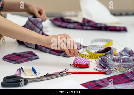 work tools on the table in a tailors workshop - meter, scissors, needle Stock Photo
