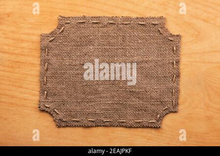 Frame of burlap, lies on a background of wood Stock Photo