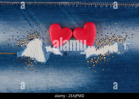The concept of two lovers hearts lying on the jeans Stock Photo