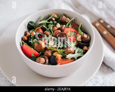 Salad with arugula, mini champignons Stock Photo