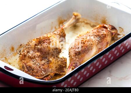 baked goose legs with cumin in frying pan Stock Photo