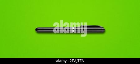 Black felt pen isolated on green banner Stock Photo