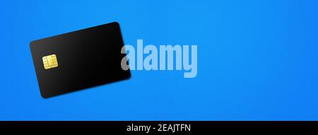 Black credit card on a blue background Stock Photo