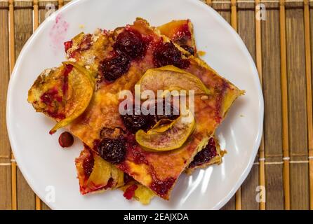 Homemade cookies with fruit in a white saucer on a bamboo mat, close up Stock Photo
